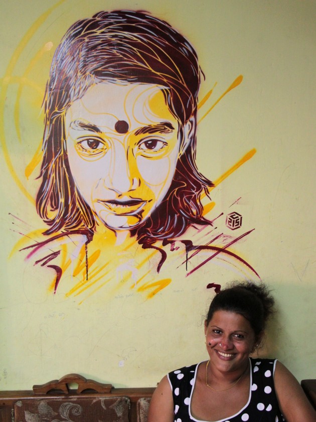 Kanchana with C215’s art on her living room wall